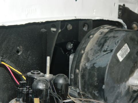 1979 Ford Bronco - Close-up view of the brake booster and master cylinder assembly, showing various components and a label with part information.