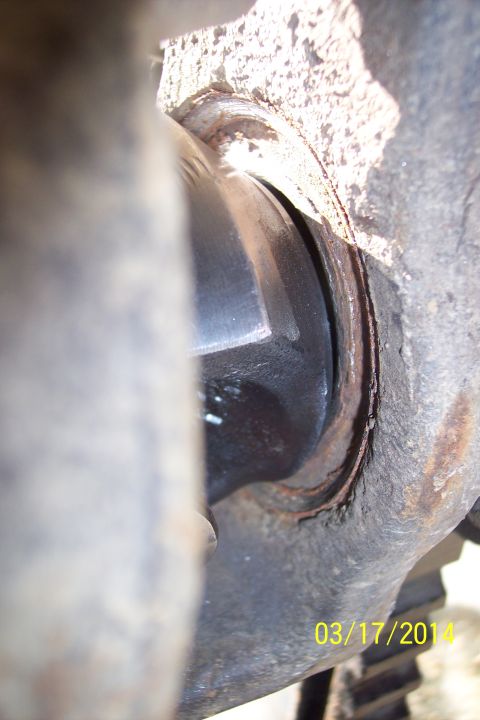1973 Ford F-250 - Close-up of a vehicle's front axle knuckle joint with a date stamp of 03/17/2014.