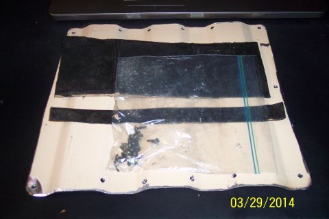 1990 Ford Bronco - A metal access panel with black tape and a bag of screws is shown.
