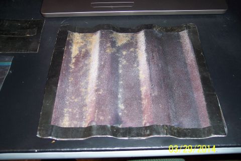 1990 Ford Bronco - A corrugated metal panel with black trim is shown, possibly a part from a vehicle.