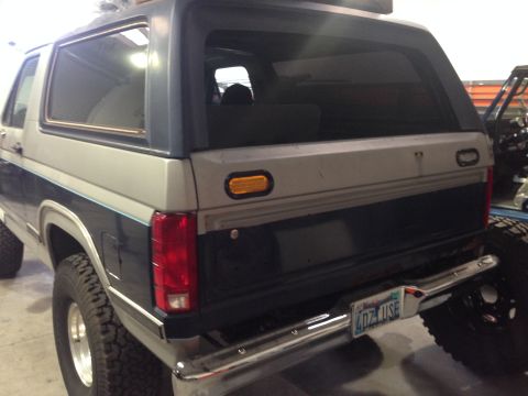 1986 Ford Bronco - This Ford Bronco features a two-tone paint scheme and a prominent chrome bumper.