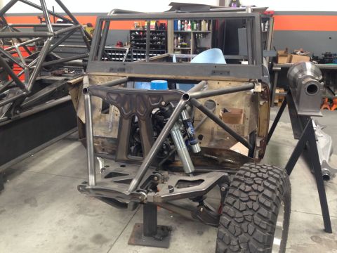 1986 Ford Bronco - This vehicle is undergoing extensive modifications in a workshop, with a focus on its chassis and suspension systems.