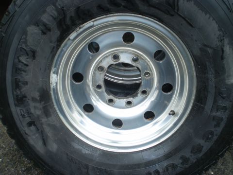 1979 Ford Bronco - Close-up of a chrome wheel and tire, likely for sale.