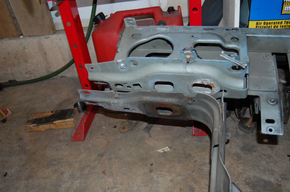 Car frame part on red stand