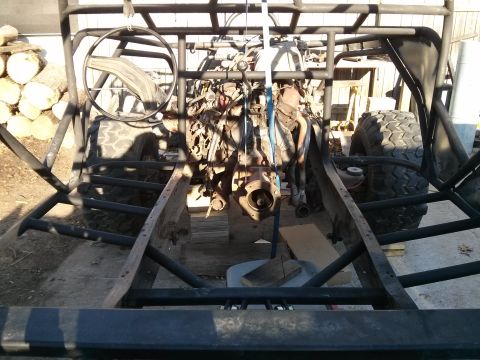 1986 Ford Bronco - The frame and engine of a custom off-road buggy are visible, suggesting a project in progress.