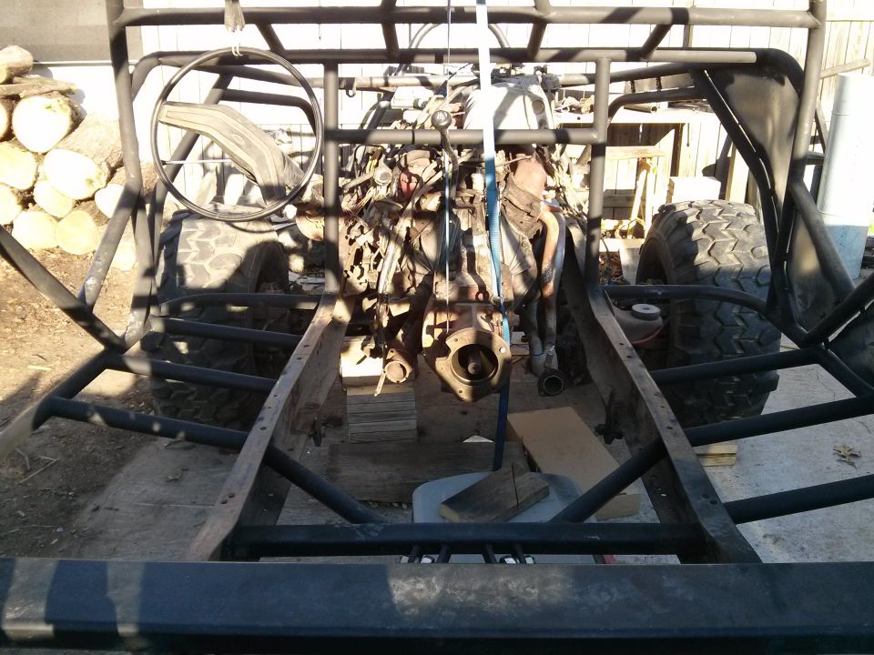 Off-road buggy frame with engine being worked on