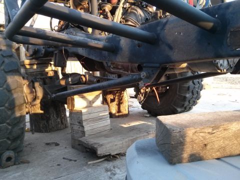 1986 Ford Bronco - Custom off-road vehicle chassis undergoing work, supported by wooden blocks.