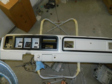 1979 Ford Bronco - A vehicle's dashboard assembly, likely removed for restoration or repair, is shown with its instrument cluster and various openings.