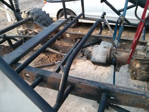 1986 Ford Bronco - Frame and drivetrain components of a custom off-road vehicle are shown during assembly.