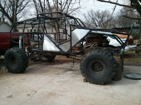1986 Ford Bronco - Custom off-road buggy frame under construction, a roll cage and large tires.