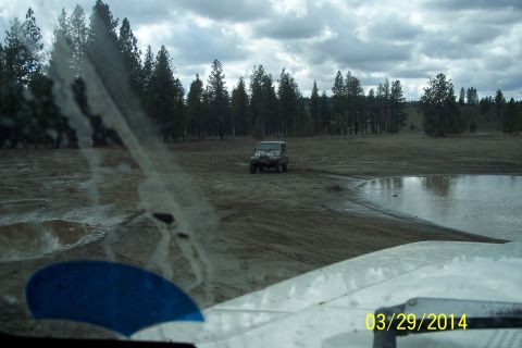 2005 Jeep Wrangler - A 2005 Jeep Wrangler navigates an off-road trail on a cloudy day.