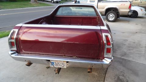 1972 Ford Ranchero - Rear view of a maroon 1972 Ford Ranchero parked on a driveway with other vehicles in the background.