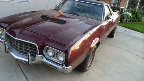 1972 Ford Ranchero - This 1972 Ford Ranchero features a distinctive grille and dual hood scoops, presented in a three-quarter front view.