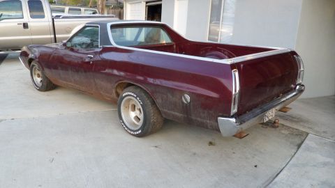 1972 Ford Ranchero - Maroon 1972 Ford Ranchero with a black vinyl top and aftermarket wheels.