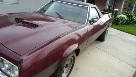 1972 Ford Ranchero - This 1972 Ford Ranchero features a distinctive hood with dual scoops, visible from a three-quarter front perspective.