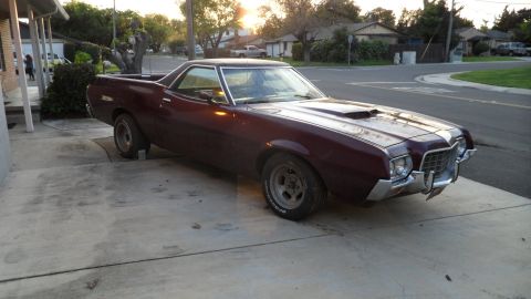 1972 Ford Ranchero - Maroon 1972 Ford Ranchero with a hood scoop sits on a concrete driveway.