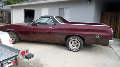 1972 Ford Ranchero - This 1972 Ford Ranchero is parked outside a garage with a trailer in front.