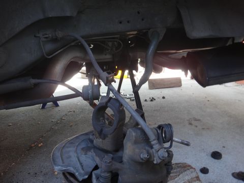 1993 Ford Taurus - The underside of a vehicle shows the brake assembly and suspension components, suggesting maintenance or repair work.