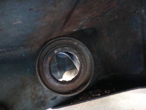 1993 Ford Taurus - A close-up view of a worn suspension component, showing rust and debris around a central opening.