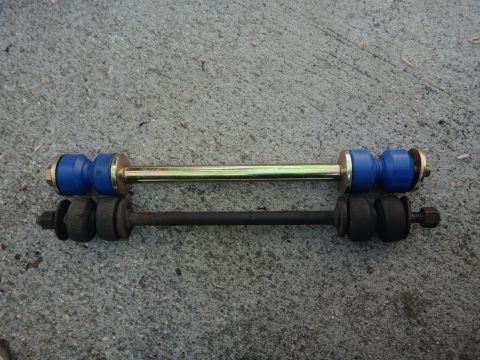 1993 Ford Taurus - Comparison of new and old sway bar links, showing the difference in wear and material.