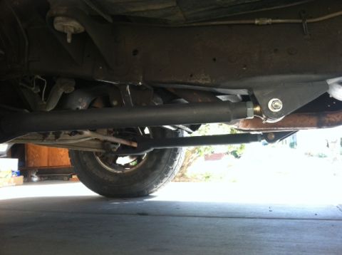 1977 Ford F-350 - Undercarriage view of a truck, focusing on suspension components and a tire.