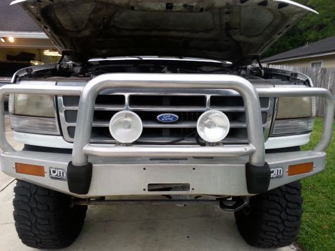 1992 Ford Bronco - Factory headlights. After 22 years, the lenses are completely yellowed, seals shot, and they've reached the end of their life cycle.