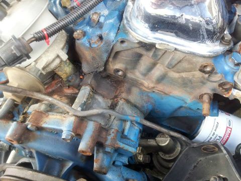 1976 Ford Ranchero - Close-up of an engine component showing blue paint, rust, and a Motorcraft oil filter.