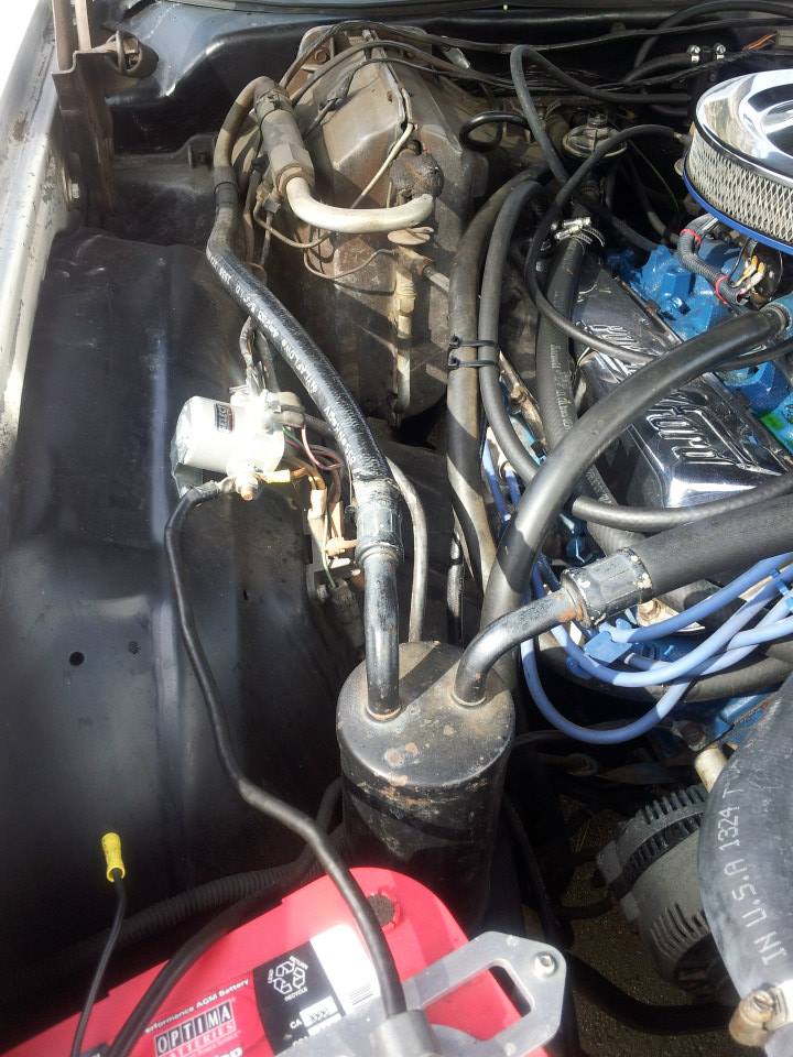 Engine bay showing AC receiver-drier and hoses