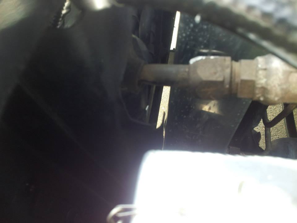 Close-up of a metal line with a fitting, possibly part of an AC system