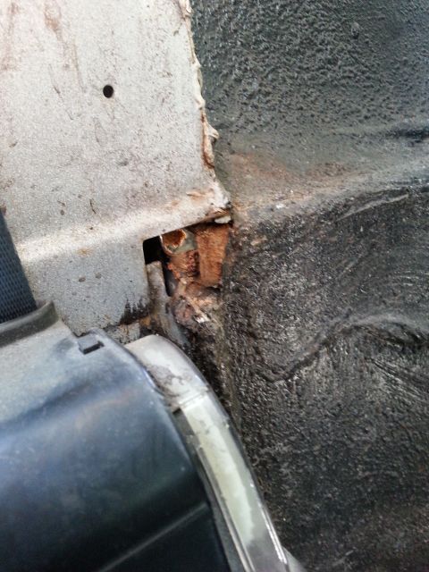1992 Ford Bronco - this is a shot of the passenger side from the rear seat near the seat belt. This hole was covered up with some sort of foam from the factor…