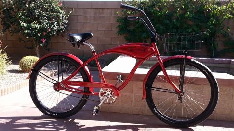 1997 Ford Ranger - A red cruiser bicycle is parked outdoors in front of a brick wall and some plants.