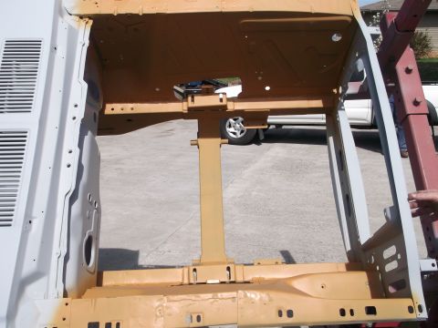 1967 Ford Mustang - The bare frame of a vehicle is shown, possibly undergoing restoration or repair.