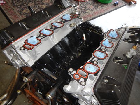 2003 Ford Crown Victoria - Close view of a V8 engine valley with new red intake manifold gaskets set in place and ports masked with tape.
