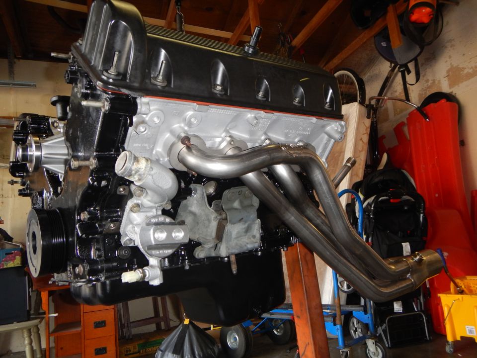Assembled V8 engine on stand with tubular stainless headers attached