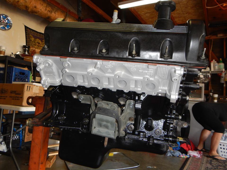 Assembled V8 long block with black valve cover and bare aluminum intake side