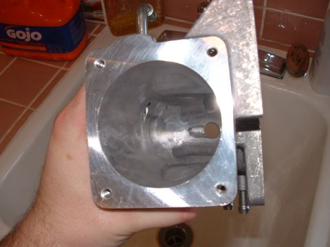 1998 Ford Crown Victoria - An aluminum intake manifold part is shown being held in a hand, with a Gojo bottle visible in the background.