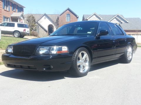 2003 Mercury Marauder - A black 2003 Mercury Marauder sedan is shown from a three-quarter front angle on a sunny day.