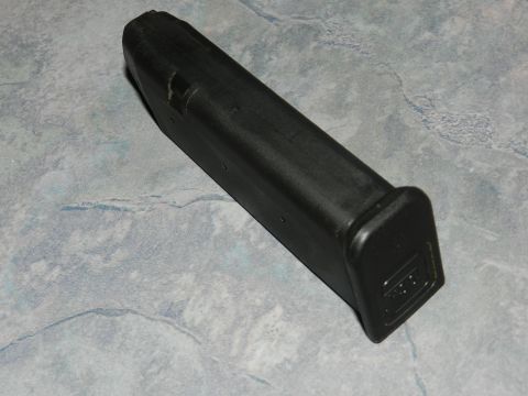 1996 Ford Bronco - A black gun magazine with a visible "GLOCK" logo is shown against a textured gray background.