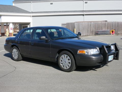 2001 Ford Crown Victoria - 2001 Ford Crown Victoria sedan, equipped with a push bar, seen from the front-three-quarter angle.