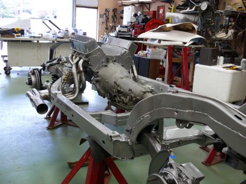 Chevrolet Corvette chassis on jack stands with engine and transmission installed