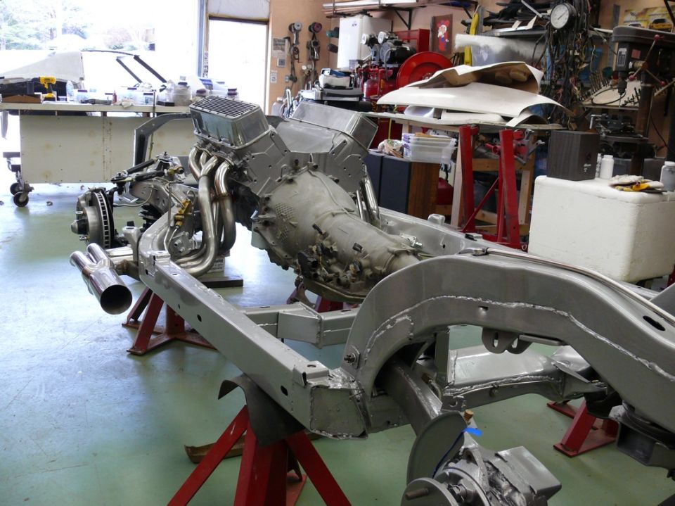 Chevrolet Corvette chassis on jack stands with engine and transmission installed