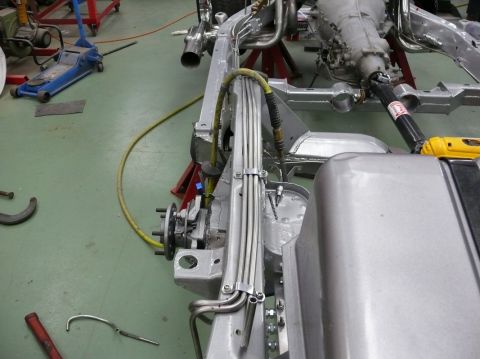 car frame with transmission and driveshaft, on jack stands