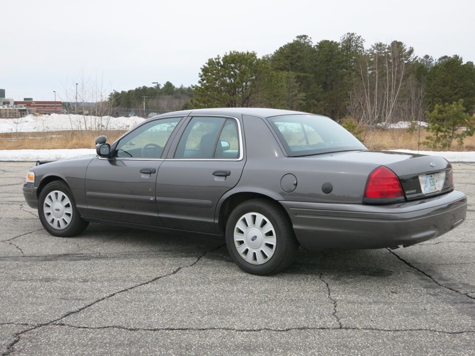 Grey 2001 Ford Crown Victoria, rear 3/4 view