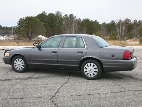 2001 Ford Crown Victoria - Side profile of a grey 2001 Ford Crown Victoria sedan.