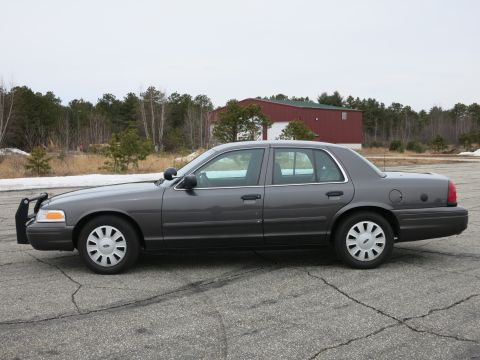 2001 Ford Crown Victoria - Side profile of a dark grey 2001 Ford Crown Victoria, equipped with a push bumper.