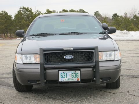 2001 Ford Crown Victoria - This Ford Crown Victoria, likely a police vehicle, is shown from the front with a push bar and a New Hampshire license plate.