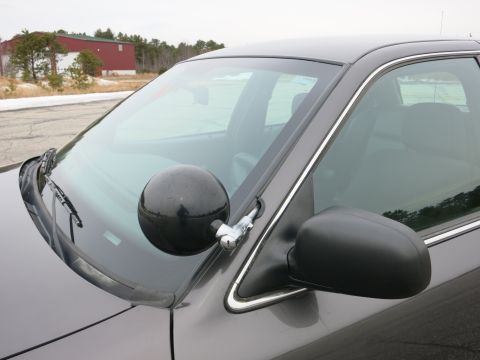 2001 Ford Crown Victoria - Close-up of a 2001 Ford Crown Victoria showing the driver's side A-pillar with a spotlight attached.