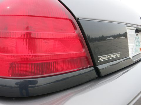 2001 Ford Crown Victoria - Close-up of the rear of a Ford Police Interceptor, highlighting the taillight and emblem.