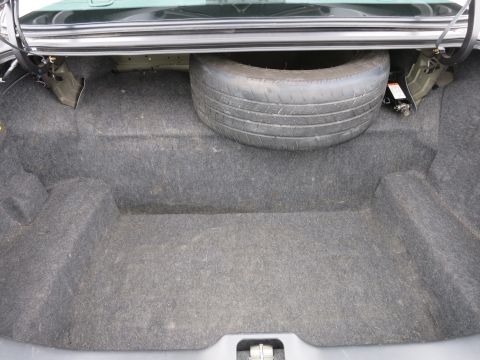 2001 Ford Crown Victoria - The interior of a car trunk is shown, containing a spare tire and jack.