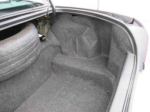 2001 Ford Crown Victoria - Trunk interior of a 2001 Ford Crown Victoria, showing the spare tire and carpeting.
